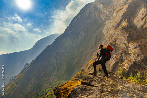 Male trekker in Himalayan mountains and forests in Manaslu region, Nepal. 