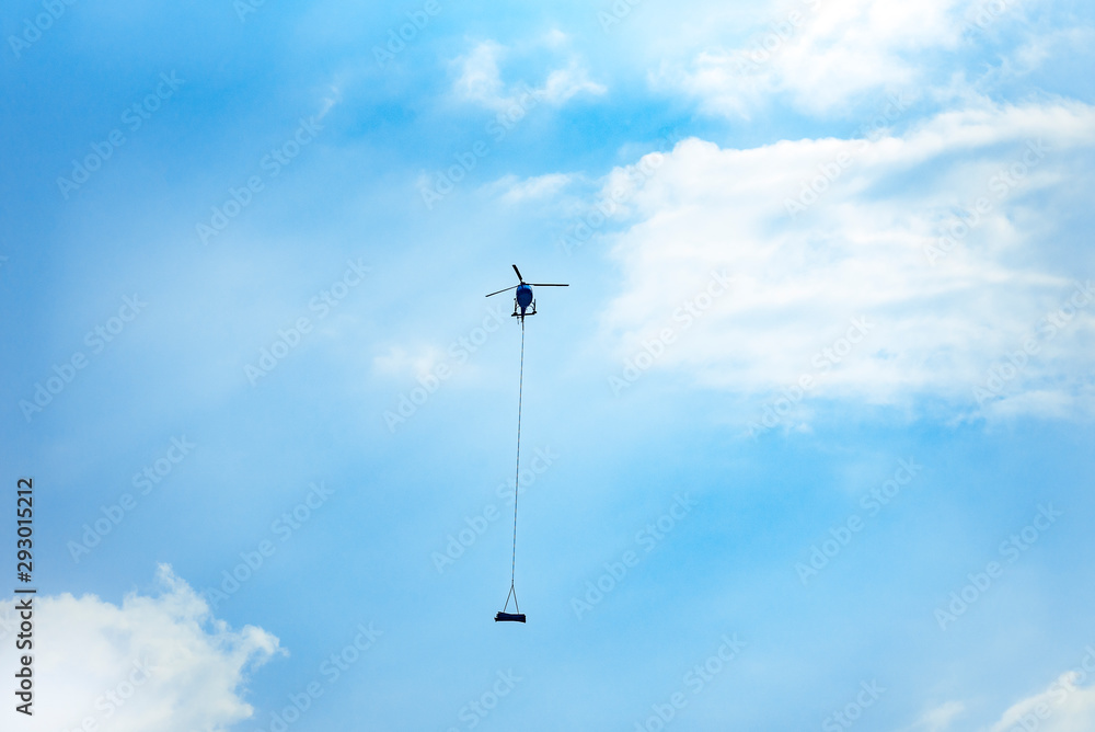 Helicopter in the sky carrying freight in mountains. Helicopter in the sky carrying freight in mountains.