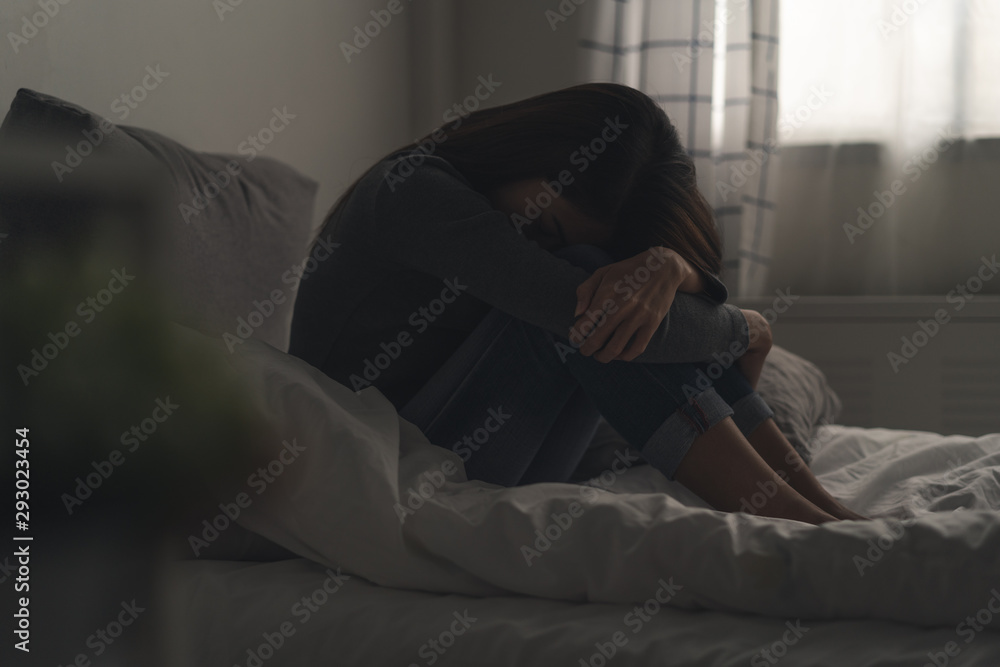 Suffer from depression , mental health problem. asian young woman sitting on the bed feeling depressed. Suffer from depression , mental health problem. asian young woman sitting on the bed feeling depressed.