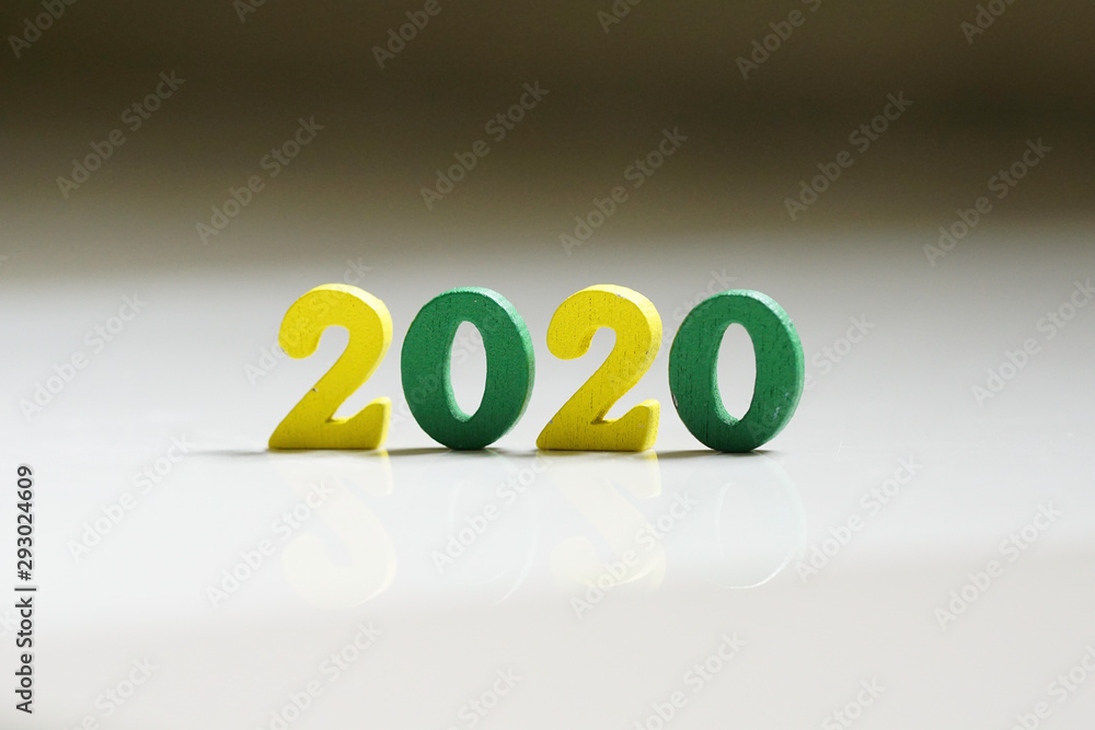 Φωτογραφία Colourful 2020 wording  made of by a wooden numeric letter on white background