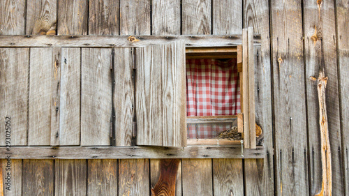 weathered wood farmhouse with open window