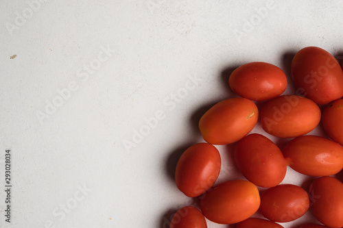 grape tomatoes scattered on white background
