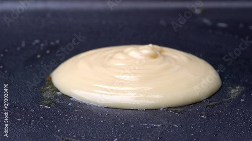 4K Close up shot of pouring pancake batter in hot frying pan with melting butter. Making pancake homemade recipe pancake for family delicious breakfast meal. photo