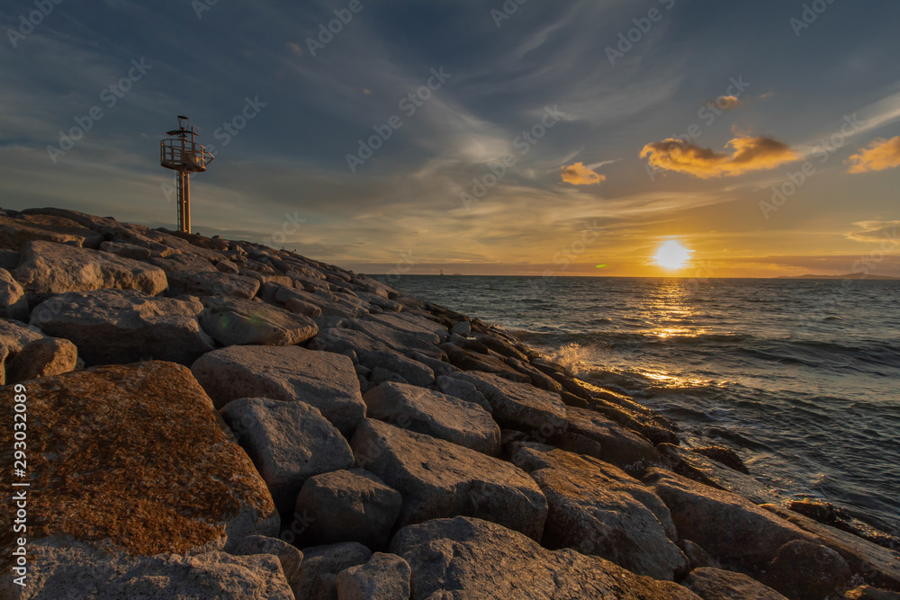Lighthouse with sunset atmosphere and a beautiful evening sky at Ban Amphur Pattaya Beach Thailand.