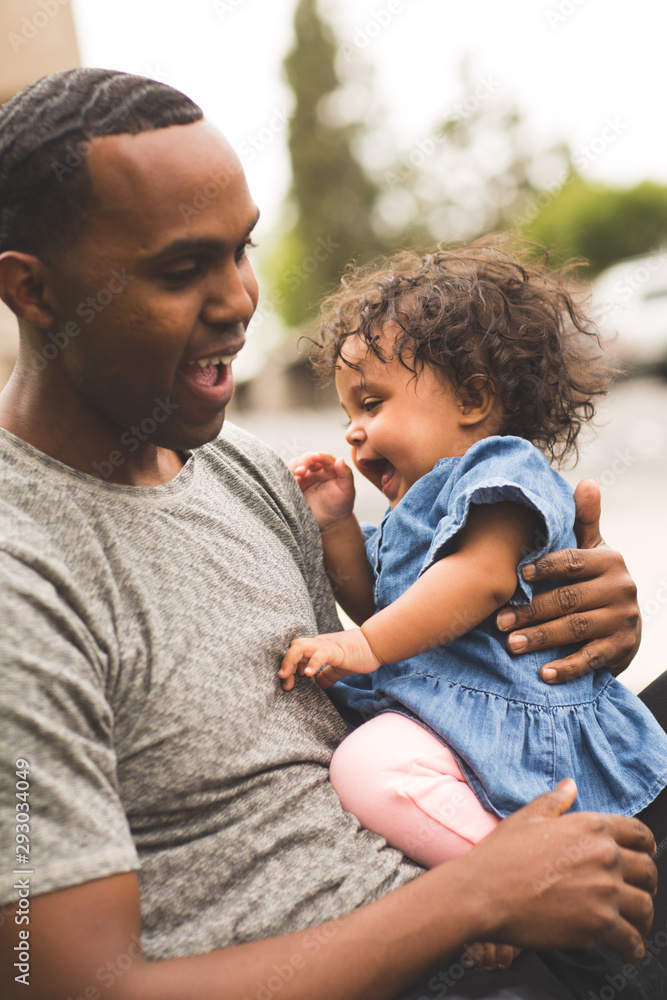 Father holding his little girl. Mixed race family. Father holding his little girl. Mixed race family.