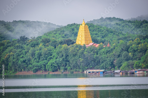 Wat Wang Wiwekaram ( Large golden chedi) likes a Babel of geometric shapes with Unseen Thailand at Sangkhlaburi Kanchanaburi (Sunset and Silhouette of temple) photo