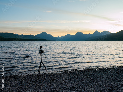 Camera taking picture of the beautiful sunrise of the Lake Mcdonald