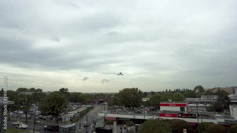Fast airplane landing on runway at Berlin Tegel Airport on cloudy day Fast airplane landing on runway at Berlin Tegel Airport on cloudy day
