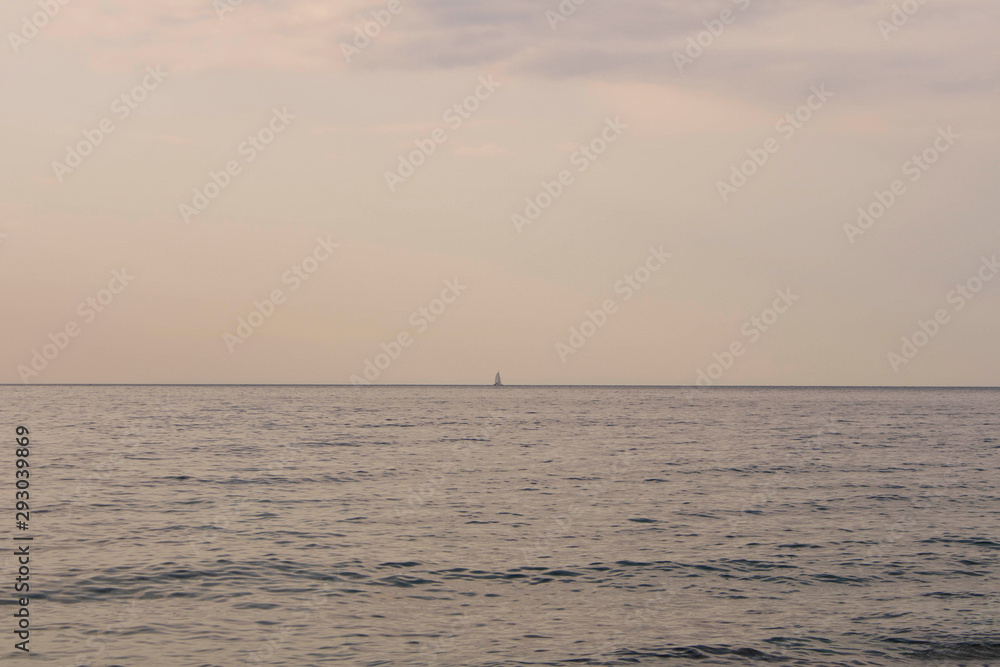 Sailboat on the horizon at sea. Sailboat in the Adriatic sea.
