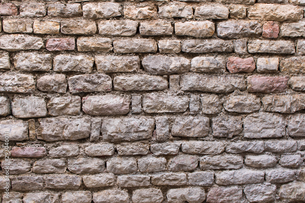 Background texture of the old fortress stone wall. Conceptual background for designers. Selective focus.