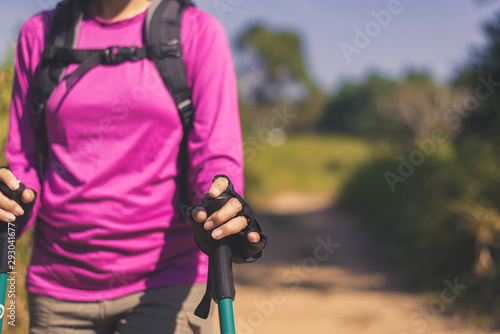 Close up of hands backpacking Asian woman holding trekking pole,Camping hiking concept