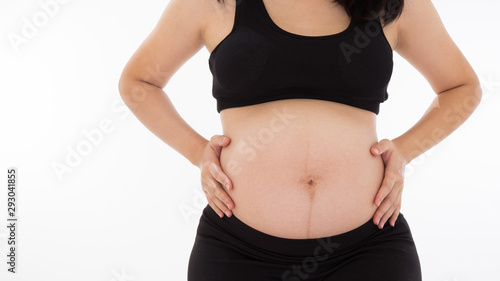 woman measuring her belly