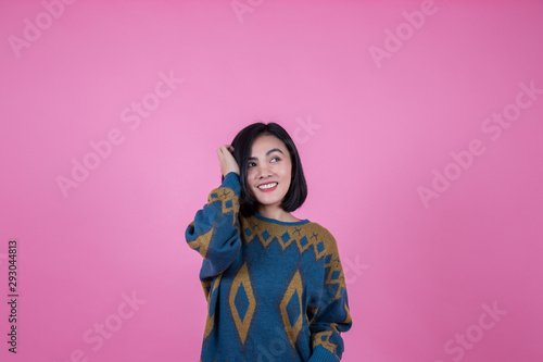 beautiful woman is stroking her own effect and the pink backdrop in the studio.