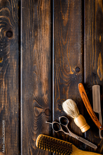 Barbershop concept. Hairdressing tools on dark wooden background top view space for text