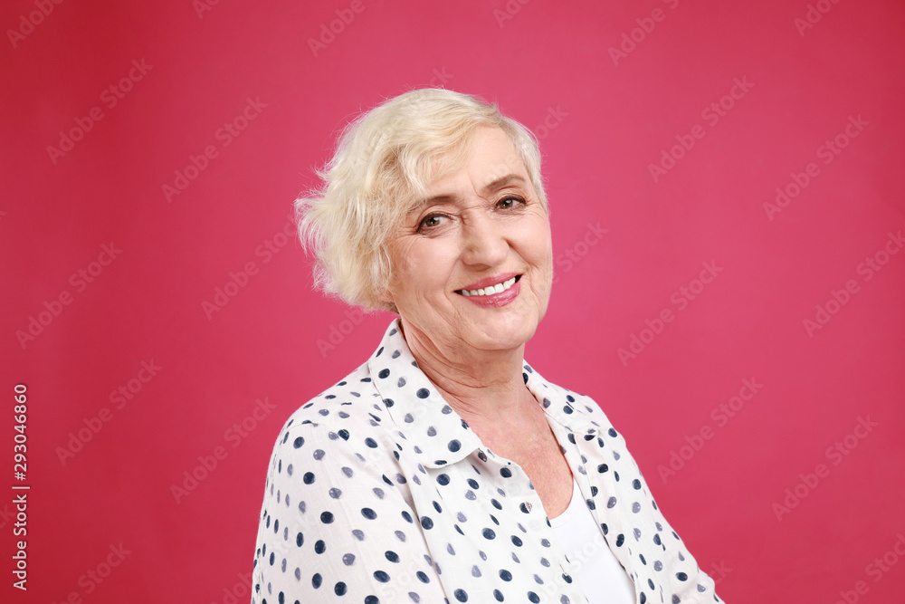 Senior woman in casual outfit on crimson background Senior woman in casual outfit on crimson background