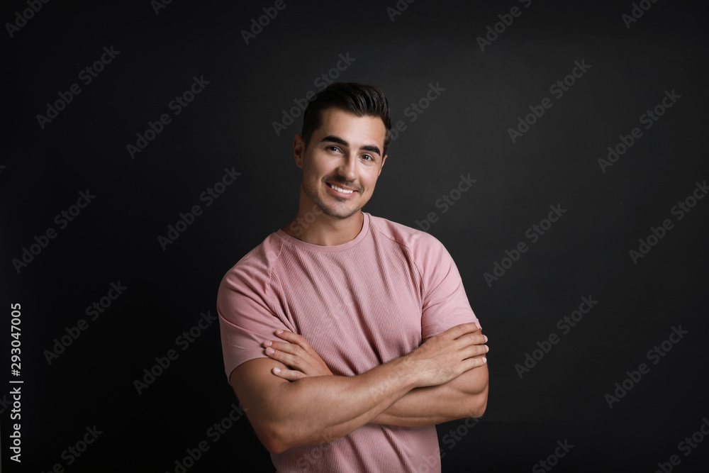 Naklejka premium Portrait of handsome young man on black background