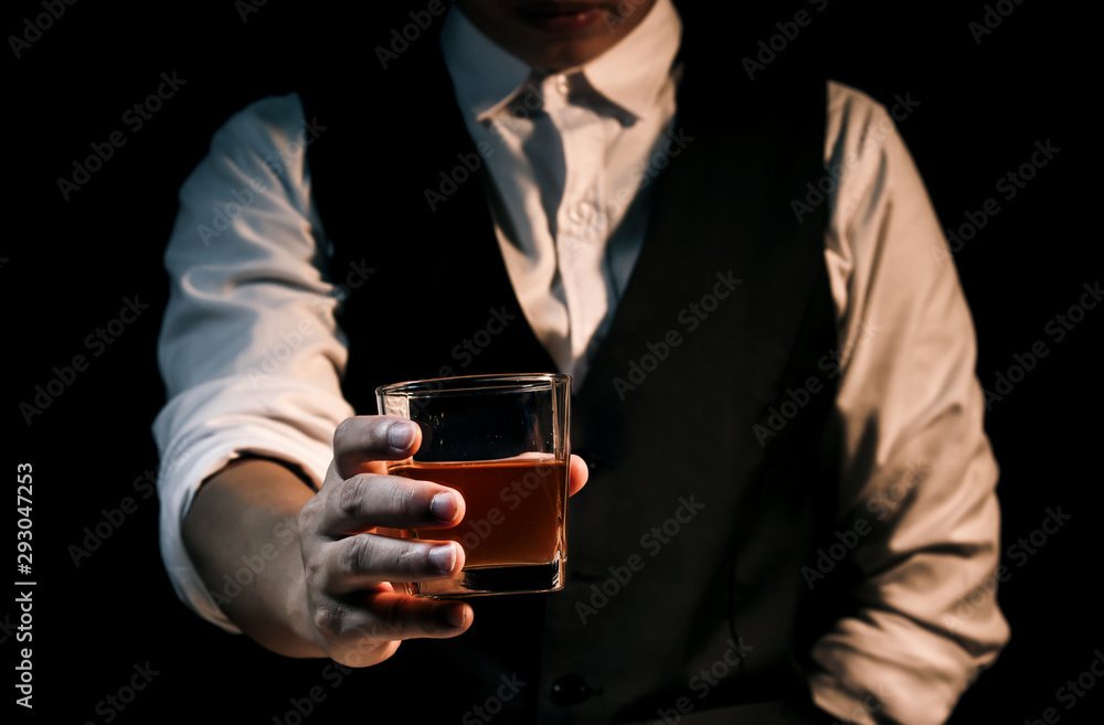 Closeup businessmen holding a glass of whiskey Closeup businessmen holding a glass of whiskey