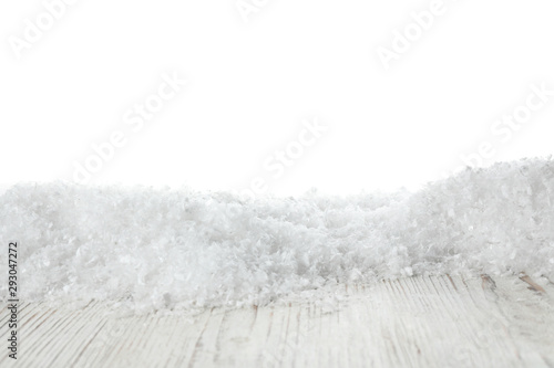 Heap of snow on wooden surface against white background. Christmas season