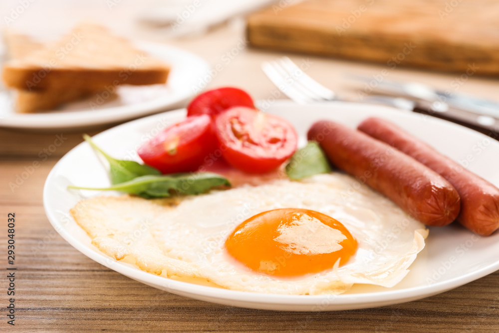 Tasty breakfast with fried egg on wooden table, closeup Tasty breakfast with fried egg on wooden table, closeup