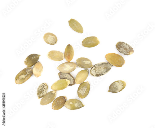 Raw peeled pumpkin seeds on white background, top view