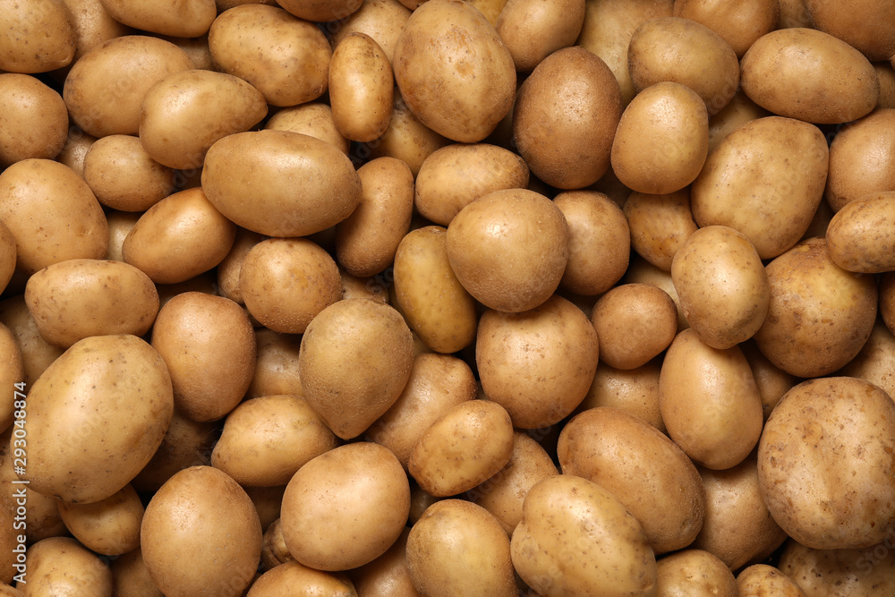 Raw fresh organic potatoes as background, top view Raw fresh organic potatoes as background, top view