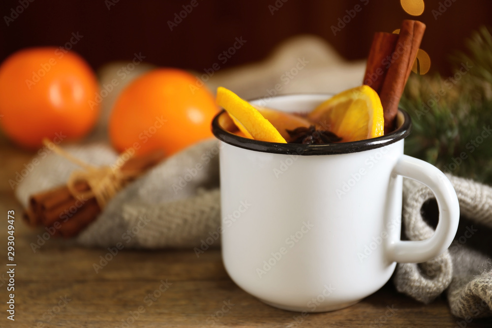 Mug with aromatic mulled wine on wooden table Mug with aromatic mulled wine on wooden table