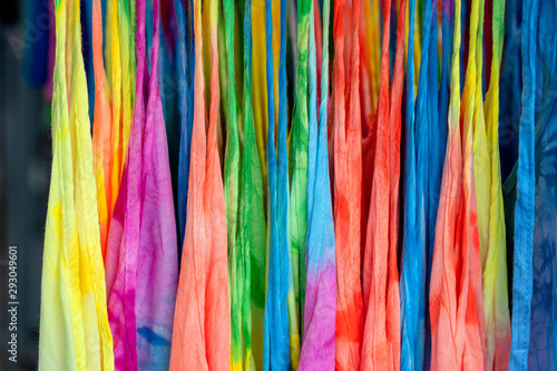 Summer clothes on hangers for sale in local street market in Thailand, close up