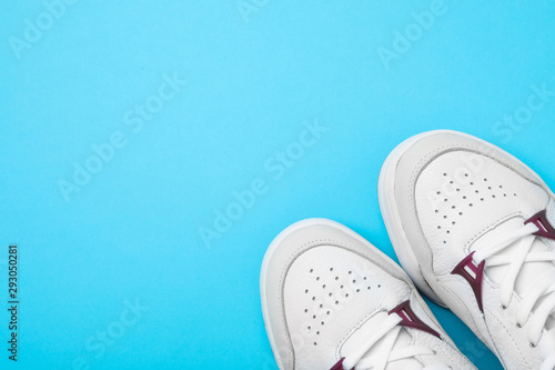 Pair of stylish shoes on blue background, top view. Space for text