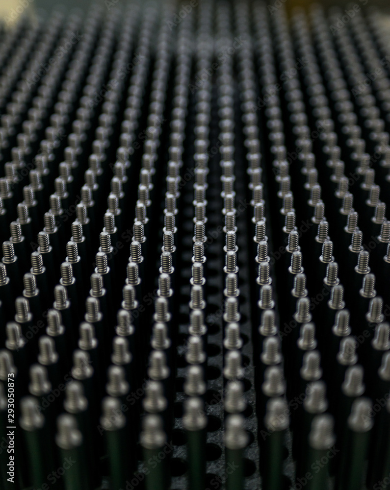 Close up shot of black screw thread bolts rowed up to a pattern background Art Close up shot of black screw thread bolts rowed up to a pattern background Art