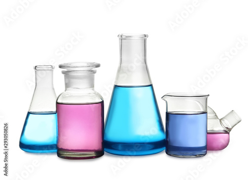 Laboratory glassware with colorful liquids on white background