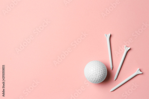 Golf ball and tees on pink background, flat lay. Space for text