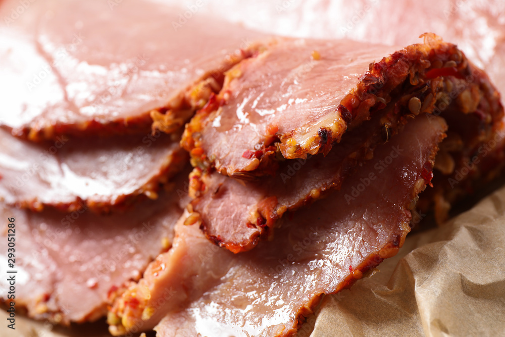 Slices of delicious cooked ham on parchment, closeup