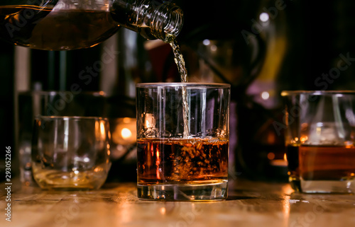 Bartender Serve Whiskey, on wood bar,  photo