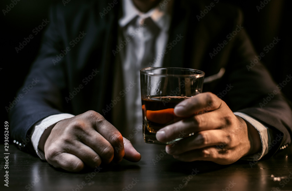 Closeup businessmen holding a glass of whiskey