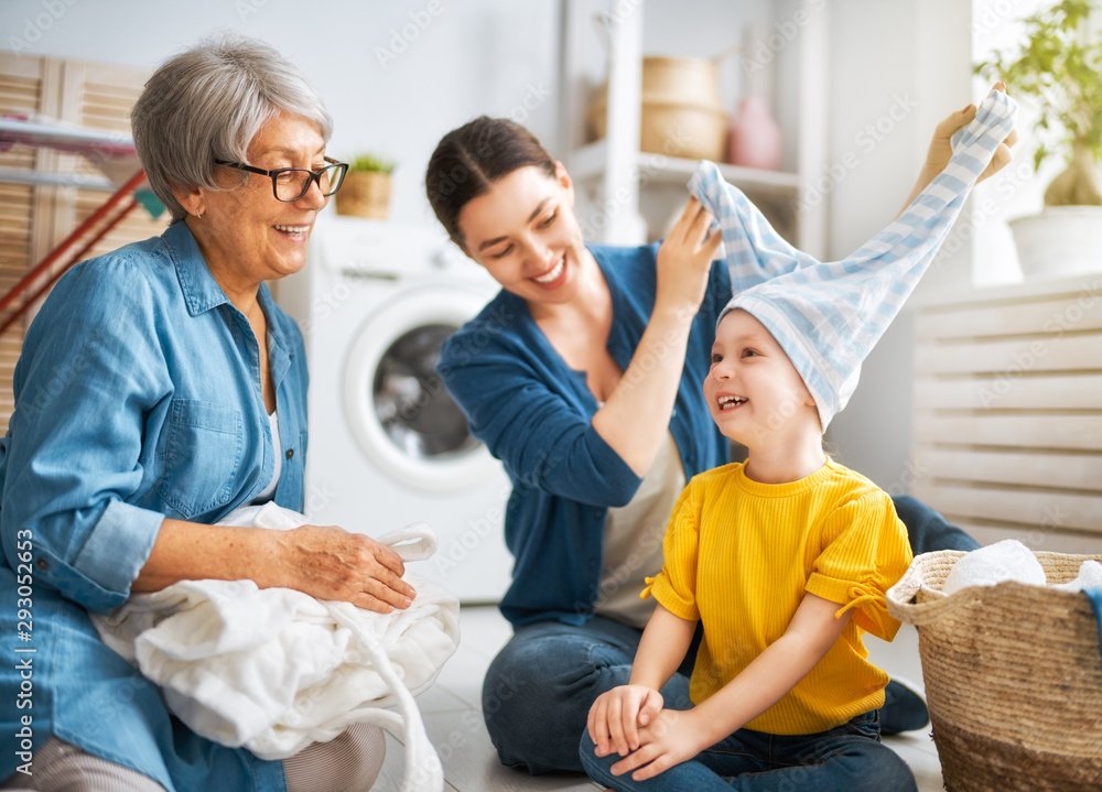grandma, mom and child are doing laundry