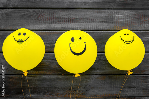 Happiness emotion. Yellow balloon with smile on blue background top view