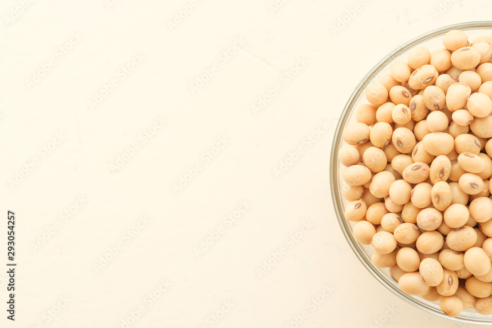 Soybeans are in a cup, placed on a wooden table with copy space,Dry bean yellow color Soybeans are in a cup, placed on a wooden table with copy space,Dry bean yellow color