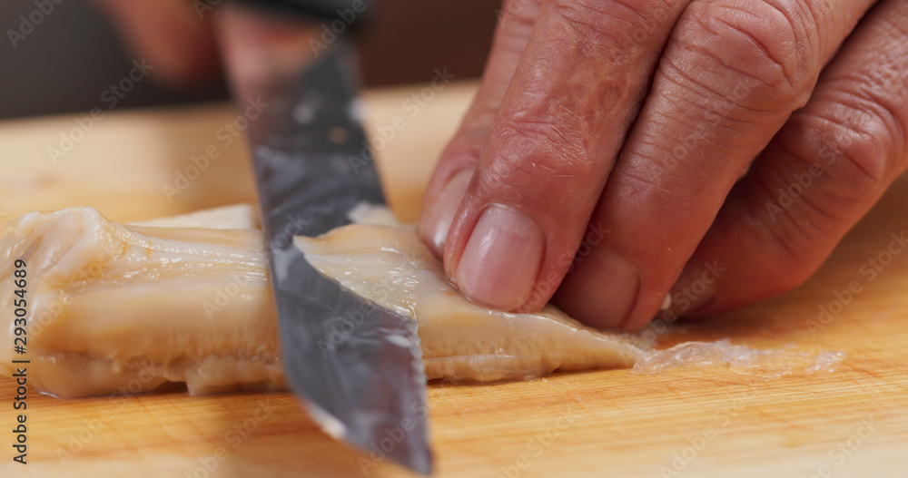 Cutting Fresh Geoduck on wooden board Cutting Fresh Geoduck on wooden board