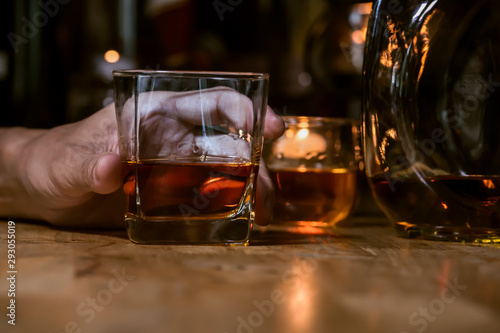 Fototapeta Naklejka Na Ścianę i Meble -  Bartender Serve Whiskey, on wood bar,