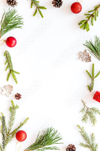 New Year decorative mockup. Fir branches and festive toys frame on white background top view copy space