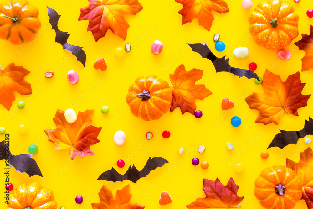 Nice halloween background with sweets. Cookies and pumpkins on yellow top view