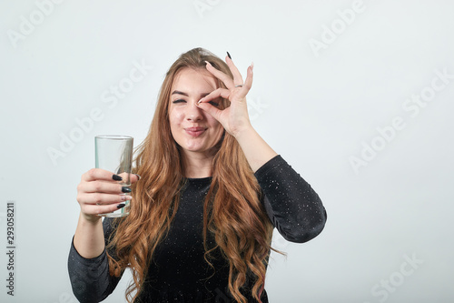 girl brown haired in black dress over isolated white background shows emotions