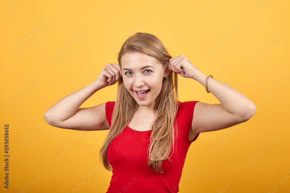 young blonde girl in red t-shirt over isolated orange background shows emotions young blonde girl in red t-shirt over isolated orange background shows emotions