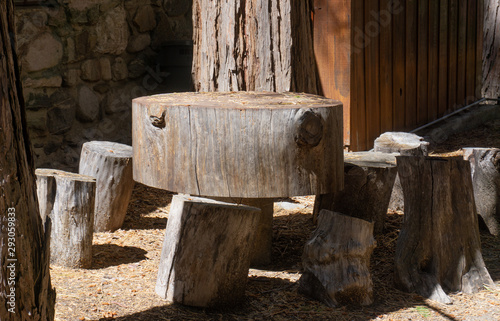 rustic table with stools made out of tree logs 