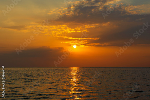 Colorful sunset over calm sea water near tropical beach. Summer vacation concept. Island Phangan  Thailand