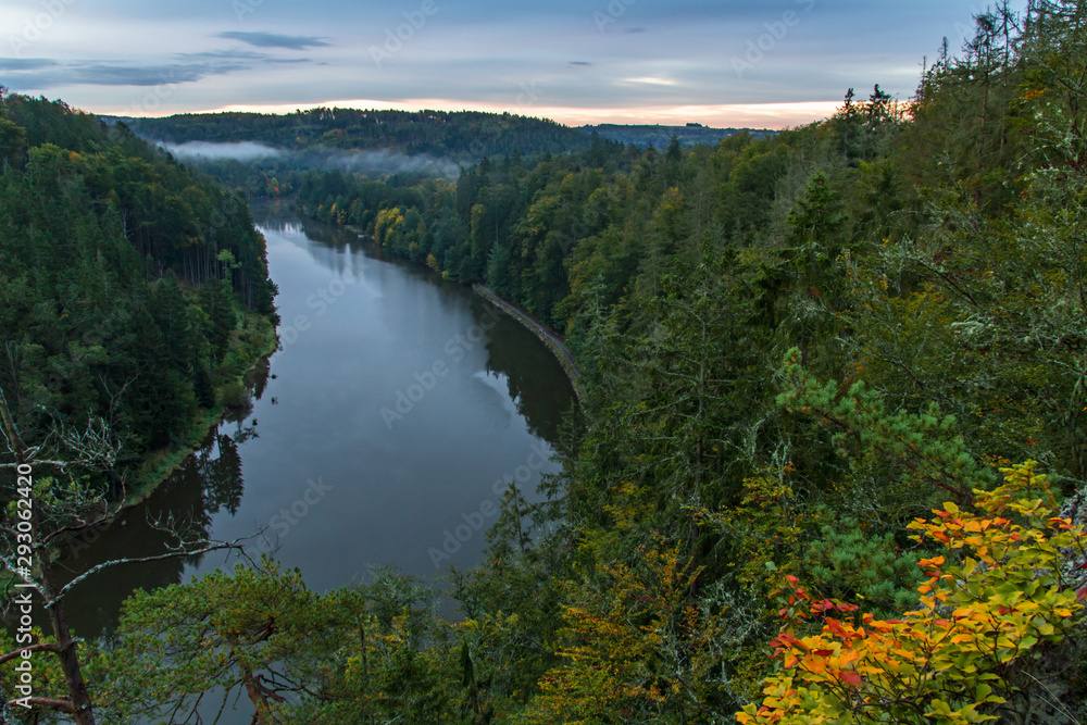 Vltava river from vantage point with autumn foliage at sunrise