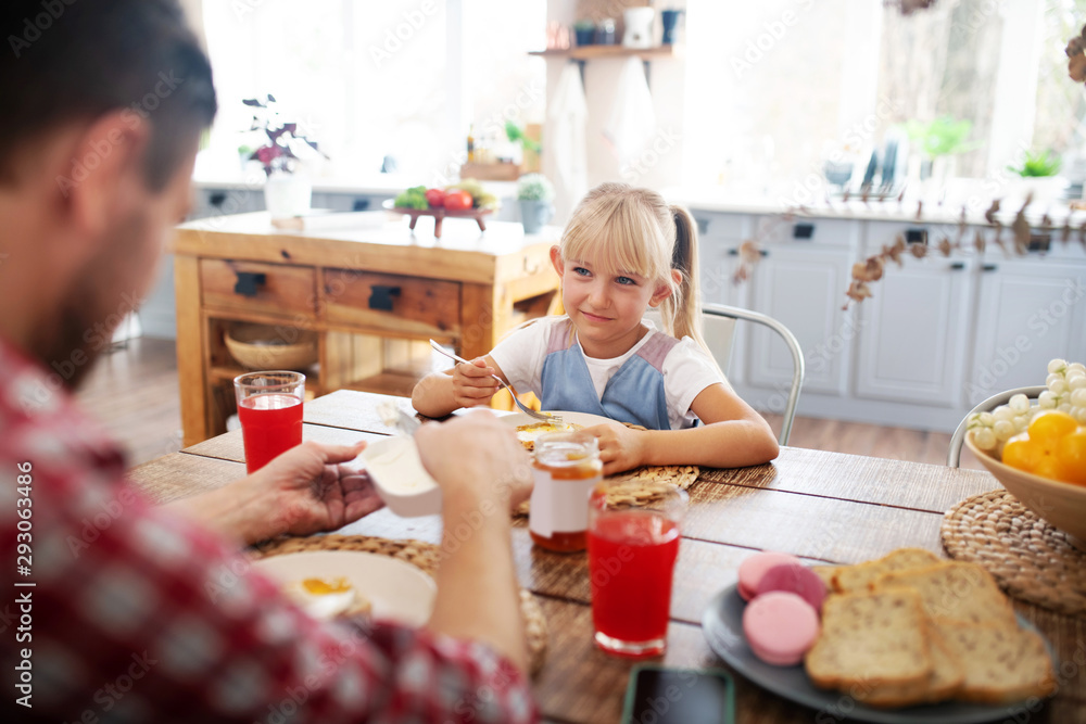Father and daughter having yummy breakfast together Father and daughter having yummy breakfast together