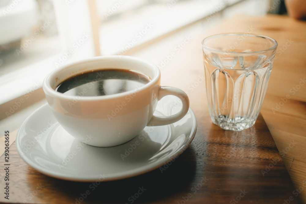 Hot cup of Americano coffee on wooden desk. Hot cup of Americano coffee on wooden desk.