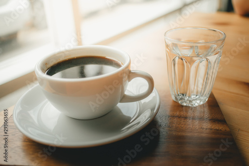 Fototapeta Naklejka Na Ścianę i Meble -  Hot cup of Americano coffee on wooden desk.