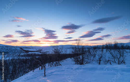 Sunset over an arctic landscape on a winters day. Lapland, Sweden.